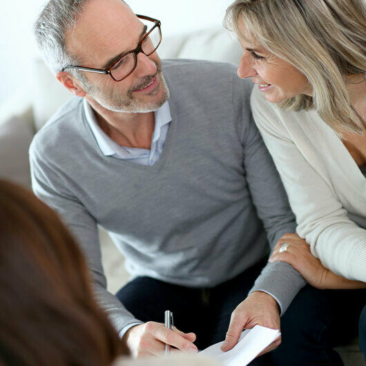 A couple discusses their banking options with their personal banker