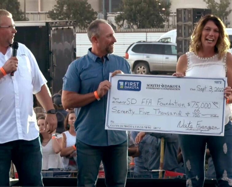 Tracy Chase receiving a check