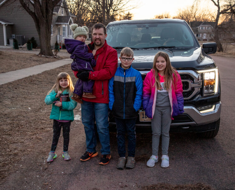 Travis and his three kids with his new F-150