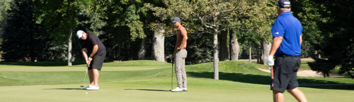 Three men golfing